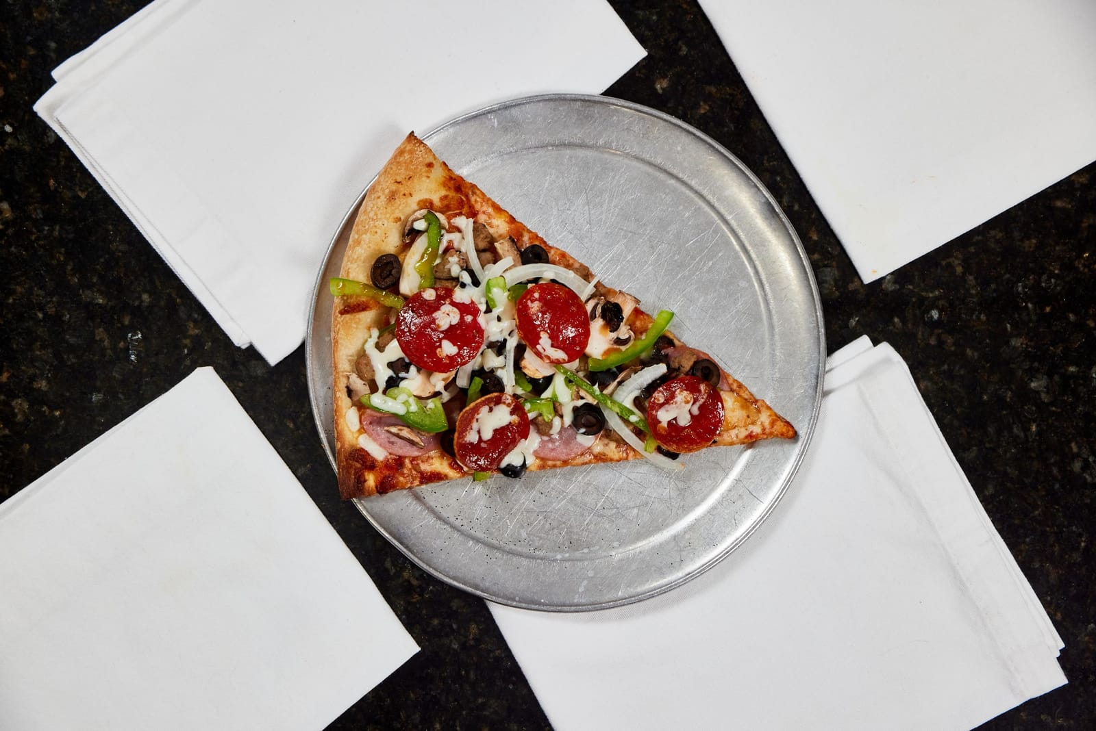 New York style supreme pizza slice